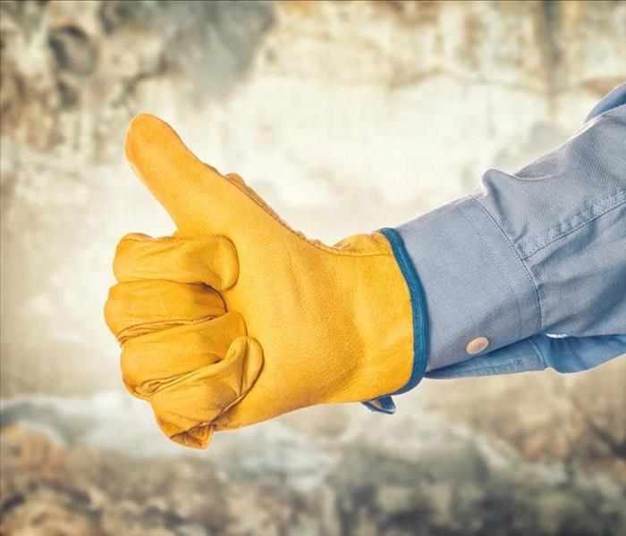 Image of a thumbs up from a person with a yellow glove