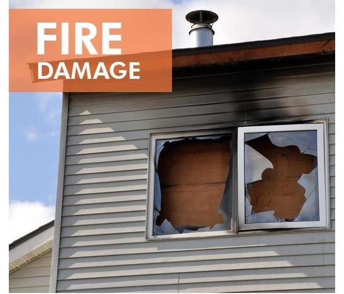 Picture of board ups placed in windows with white letters and orange background saying fire damage, 