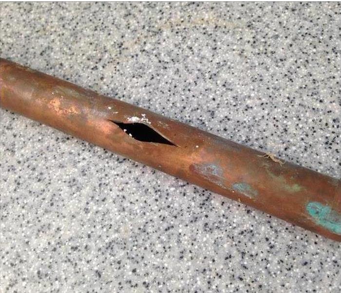 Rusty pipe damaged with hole in the middle