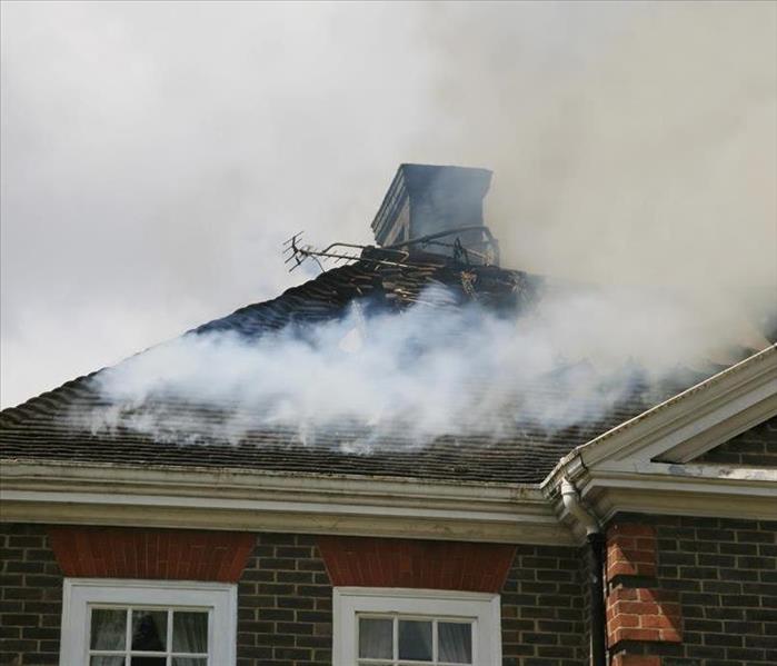Smoke rising from the Roof of a House