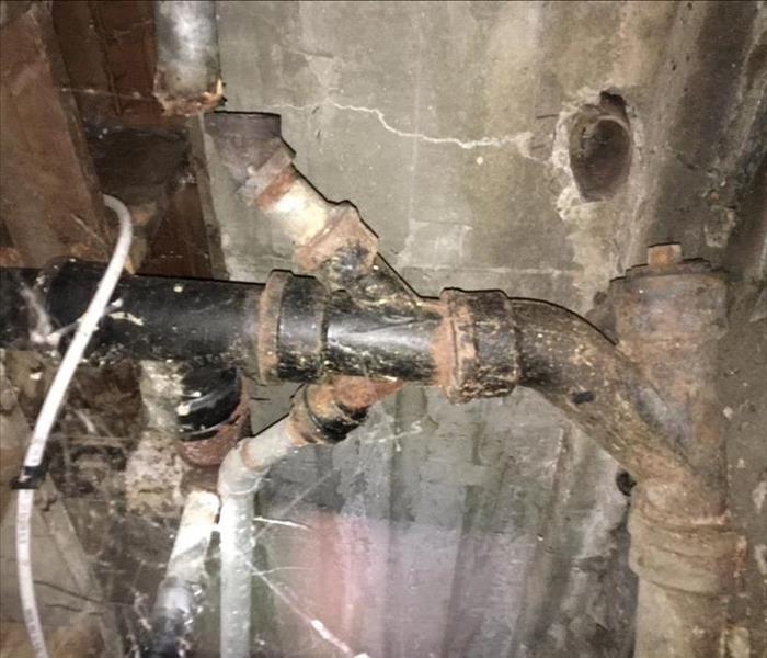 Broken pipe leaking water in residential home.